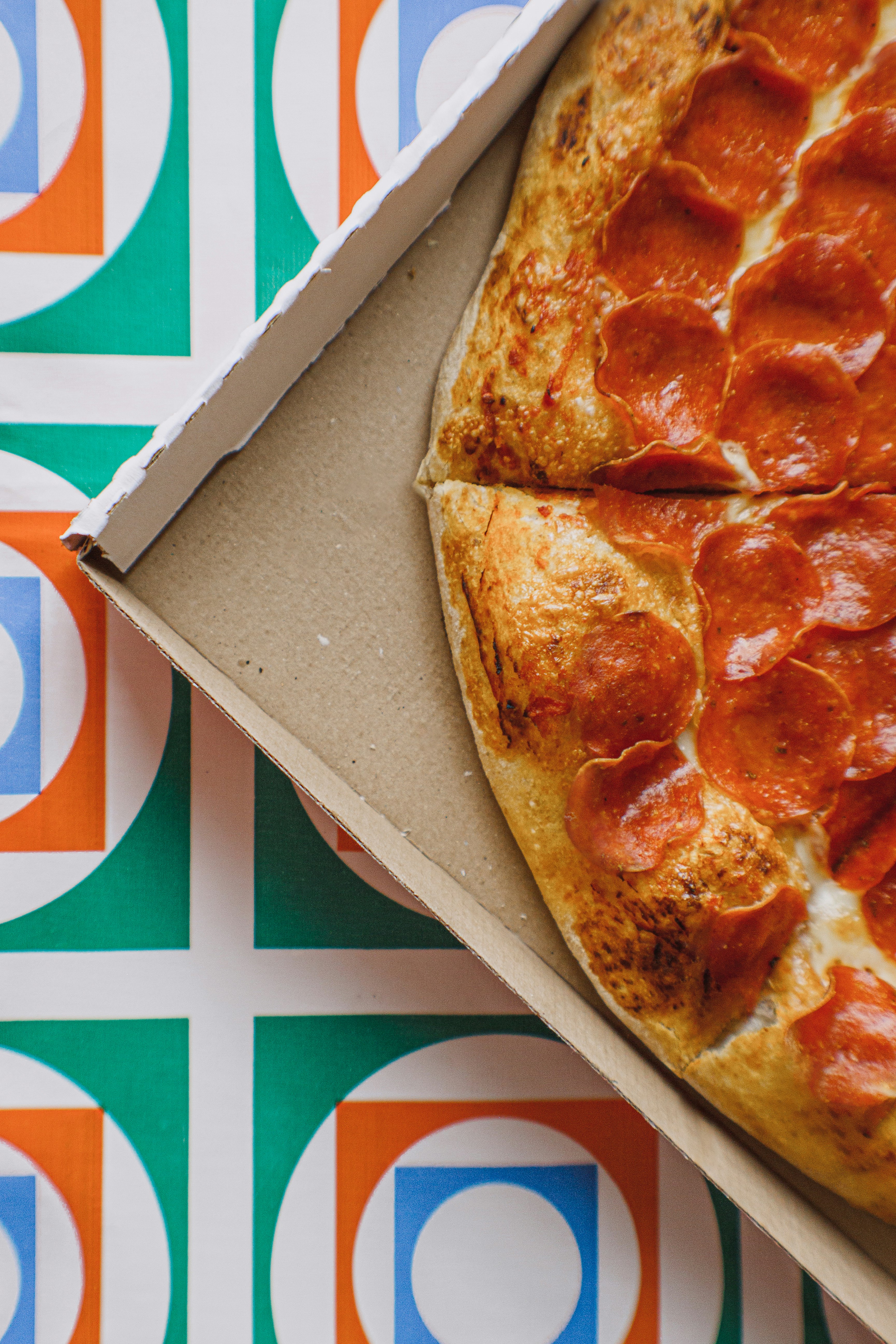 pizza on brown cardboard box